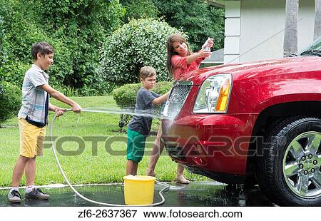 Single mother washing car at home with her two children in driveway with hose MR-11, MR-12, MR-13 Model Released. View Large Photo Image Stock Photo - Single mother washing car at home with her two children in driveway with hose MR-11, MR-12, MR-13 Model Released.. Fotosearch