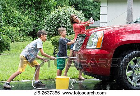 Single mother washing car at home with her two children in driveway with hose MR-11, MR-12, MR-13 Model Released. View Large Photo Image Stock Photograph - Single mother washing car at home with her two children in driveway with hose MR-11, MR-12, MR-13 Model Released.. Fotosearch