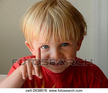 Stock Photograph - Smiling boy, 3 years old, pointing with a finger.. Fotosearch