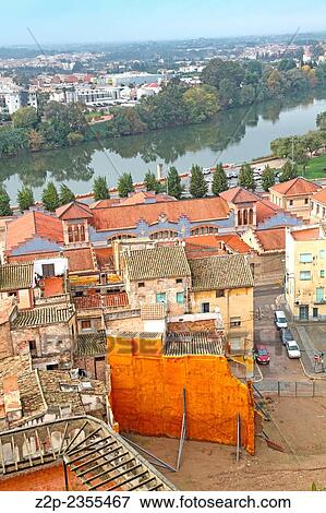 Stock Photo - Spain, Catalonia, Tarragona province, Tortosa, residential buildings next to River Ebro, view from de Parador Nacional. Fotosearch