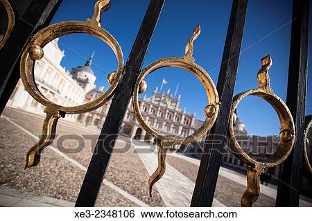 Stock Photograph - Spain, Madrid Province, Aranjuez, View of Royal Palace through architectural details of gate. Fotosearch