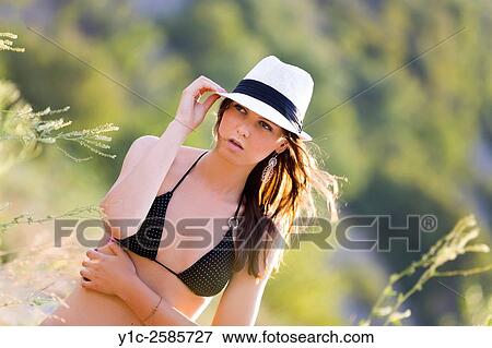 Stock Photo - Teen girl with White hat in nature. Fotosearch
