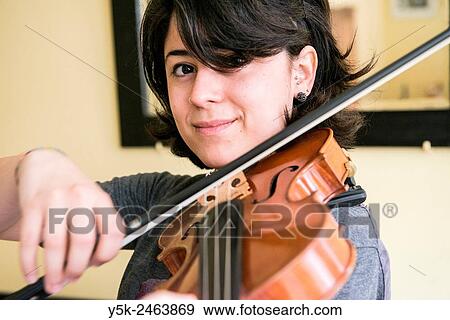 Stock Photo - Tilburg, Netherlands. Young Italian violinist practising and rehearsing, in preparation of her conservatoire exam.. Fotosearch