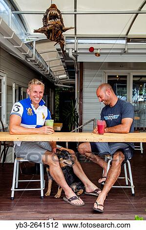 Two Men Sitting At A Beach Side Cafe/Restaurant, Waipu Cove, North Island, New Zealand. View Large Photo Image Stock Image - Two Men Sitting At A Beach Side Cafe/Restaurant, Waipu Cove, North Island, New Zealand.. Fotosearch