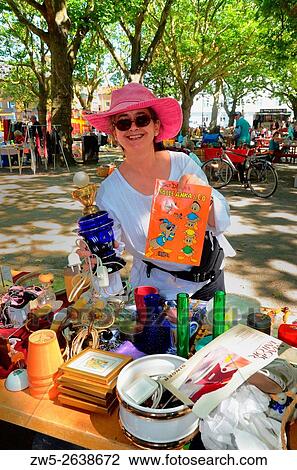 Stock Image - Woman in a flea market in Ystad, Sweden.. Fotosearch