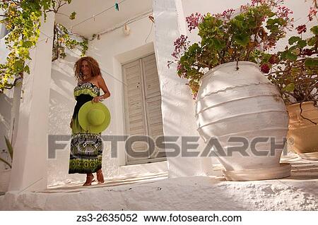 Woman in front of a trational Cyclades house at the old town Hora, Serifos, Cyclades Islands, Greek Islands, Greece, Europe. View Large Photo Image Stock Image - Woman in front of a trational Cyclades house at the old town Hora, Serifos, Cyclades Islands, Greek Islands, Greece, Europe.. Fotosearch