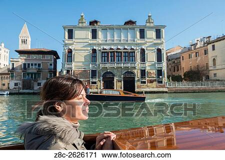 Woman travel in a taxi boat on Grand Canal in Venice, Italy. View Large Photo Image Stock Image - Woman travel in a taxi boat on Grand Canal in Venice, Italy.. Fotosearch