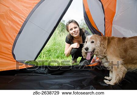 Woman watching inside a tent with her cute cocker spaniel dog in Ticino, Switzerland. View Large Photo Image Stock Photo - Woman watching inside a tent with her cute cocker spaniel dog in Ticino, Switzerland.. Fotosearch