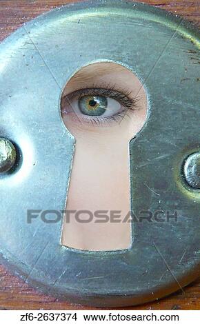 Woman with eye looking through keyhole peeping in mysterious way MR Model released. View Large Photo Image Picture - Woman with eye looking through keyhole peeping in mysterious way MR Model released.. Fotosearch