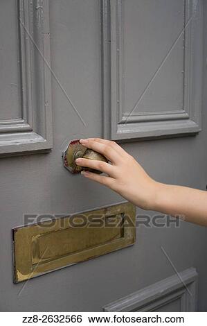 Womans hand holding a door handle. View Large Photo Image Stock Photograph - Womans hand holding a door handle.. Fotosearch