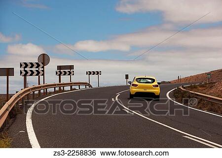 Yellow Car On The Mountain Road With Traffic Signs By Side Fuerteventura Canary Islands Spain Stock Photograph Zs3 Fotosearch