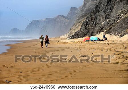 Young people on almost empty beach, Praia da Cordoama, Cordoama beach, near Vila Do Bispo, close to Sagres, Parque Natural do Sudoeste Alentejano e Costa Vicentina, South West Alentejo and Vicentine Coast Natural Park, Western Algarve, Portugal. View Large Photo Image Stock Image - Young people on almost empty beach, Praia da Cordoama, Cordoama beach, near Vila Do Bispo, close to Sagres, Parque Natural do Sudoeste Alentejano e Costa Vicentina, South West Alentejo and Vicentine Coast Natural Park, Western Algarve, Portugal.. Fotosearch