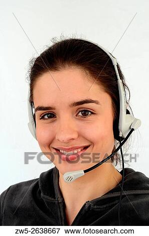 Young smiling woman, 25 years old, brunette, talking in a headset phone. View Large Photo Image Stock Photo - Young smiling woman, 25 years old, brunette, talking in a headset phone.. Fotosearch