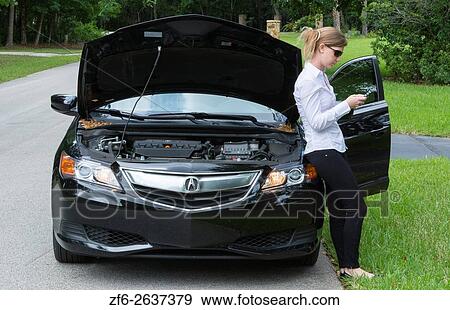 Young woman with car broken down on side of road using cell phone to call for help and being rather annoyed MR Model released. View Large Photo Image Stock Photo - Young woman with car broken down on side of road using cell phone to call for help and being rather annoyed MR Model released.. Fotosearch