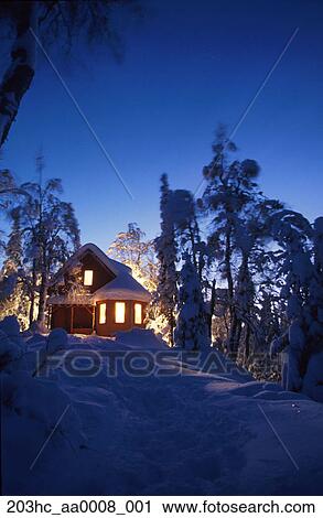 Cabin Lit At Dusk With Snow Covered Trees Alaska Winter Spruce