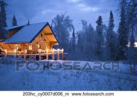 Log Cabin In The Woods Decorated With Christmas Lights At Twilight