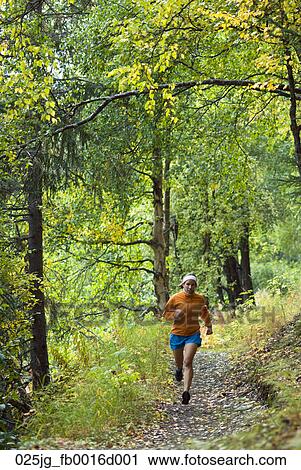 Woman Runs The Crescent Lake Trail In The Chugach National Forest