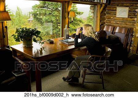 Guest Relaxes Inside Her Cabin Enjoys The View At Camp Denali