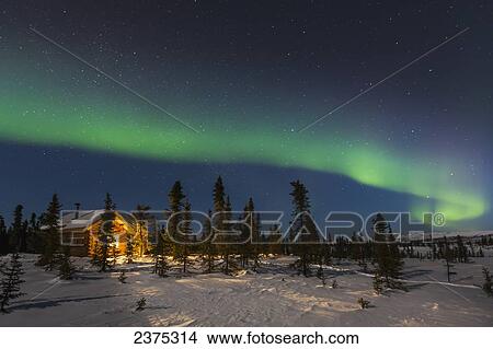 The Northern Lights Arc Over The Colorado Creek Cabin And Winter