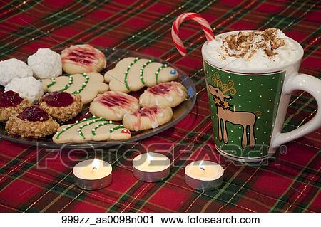 closeup of homemade christmas cookies arranged on glass plate on a red plaid tablecloth with hot chocolate drink off to the side - Homemade Christmas Cookies closeup of homemade christmas cookies arranged on glass plate on a red plaid tablecloth with hot chocolate drink off to the side - Homemade Christmas Cookies
