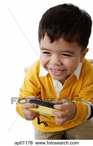 Stock Photo - Boy holding camera, laughing. Fotosearch