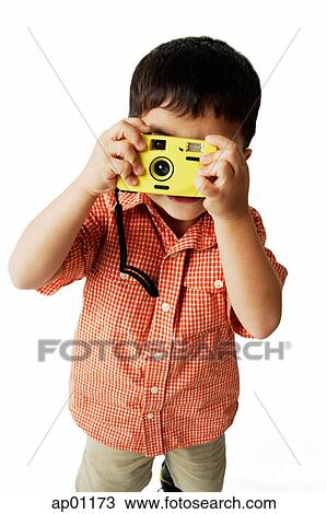 Stock Image - Boy looking through camera. Fotosearch