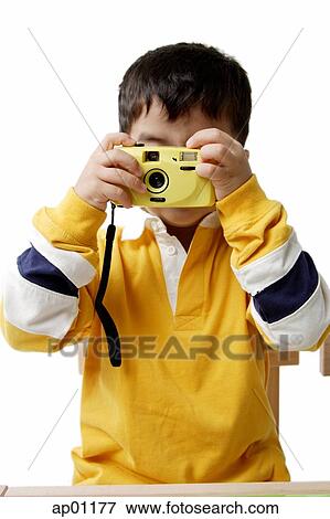 Stock Photo - Boy looking through camera. Fotosearch