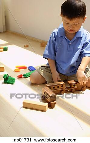 Boy playing with toy train View Large Photo Image Stock Image - Boy playing with toy train. Fotosearch
