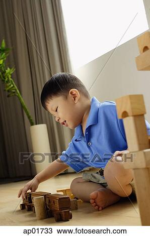 Boy playing with toy train View Large Photo Image Stock Image - Boy playing with toy train. Fotosearch
