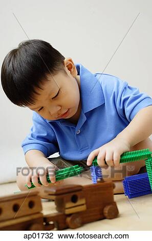 Boy playing with toys View Large Photo Image Stock Image - Boy playing with toys. Fotosearch