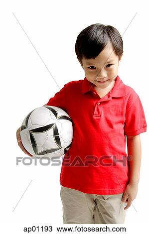 Boy smiling at camera, holding soccer ball View Large Photo Image Stock Image - Boy smiling at camera, holding soccer ball. Fotosearch