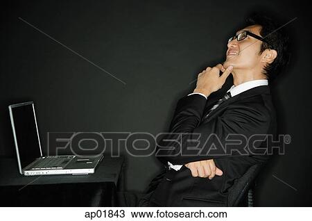 Businessman hand on chin, looking up View Large Photo Image Stock Image - Businessman hand on chin, looking up. Fotosearch