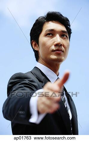Businessman, hand outstretched, selective focus View Large Photo Image Stock Image - Businessman, hand outstretched, selective focus. Fotosearch