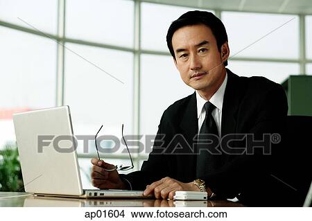 Picture - Businessman in office looking at camera. Fotosearch