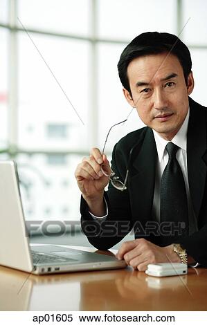 Stock Photography - Businessman looking at camera, portrait. Fotosearch