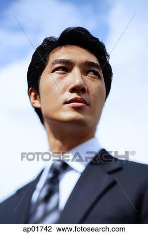 Stock Image - Businessman, looking away, head shot. Fotosearch