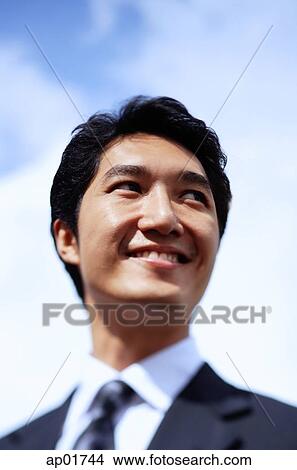 Picture - Businessman, looking away, smiling, head shot. Fotosearch