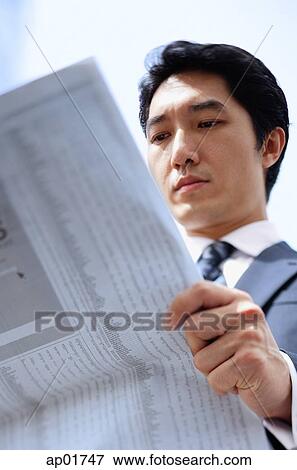 Stock Photo - Businessman reading newspaper. Fotosearch