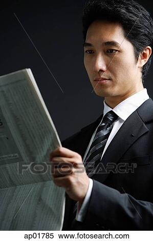 Businessman reading newspaper View Large Photo Image Stock Photography - Businessman reading newspaper. Fotosearch