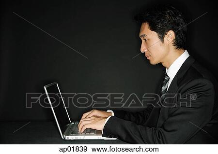 Businessman using laptop View Large Photo Image Stock Photo - Businessman using laptop. Fotosearch