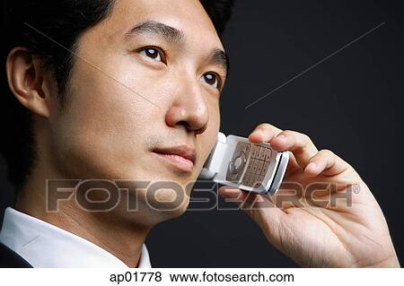 Stock Photo - Businessman using mobile phone. Fotosearch