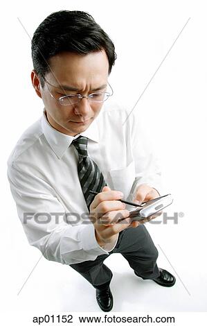 Businessman using PDA View Large Photo Image Stock Image - Businessman using PDA. Fotosearch