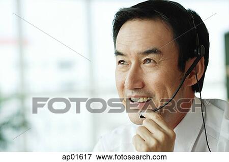 Stock Photo - Businessman wearing headset. Fotosearch