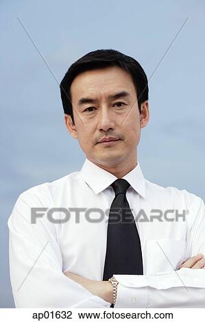 Businessman with arms crossed, looking at camera, portrait View Large Photo Image Stock Image - Businessman with arms crossed, looking at camera, portrait. Fotosearch