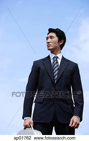 Businessman with briefcase, looking away View Large Photo Image Stock Image - Businessman with briefcase, looking away. Fotosearch