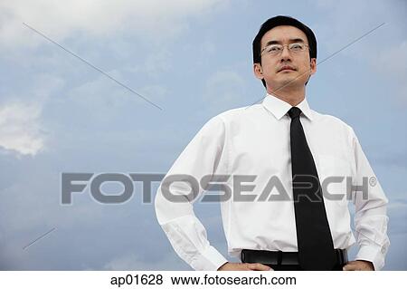 Stock Photo - Businessman with hands on hips. Fotosearch