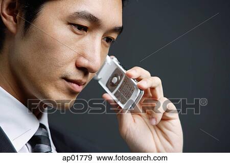 Businessman with mobile phone, head shot View Large Photo Image Stock Photo - Businessman with mobile phone, head shot. Fotosearch