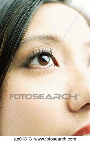 Stock Image - Close up of woman's face, focus on the eye. Fotosearch