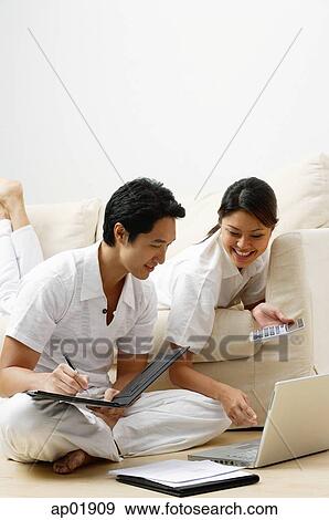 Stock Photo - Couple at home, doing home finances. Fotosearch