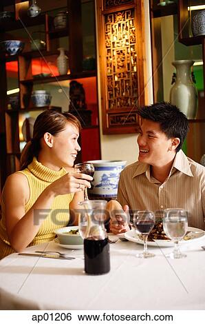 Couple dining in Chinese restaurant View Large Photo Image Stock Photograph - Couple dining in Chinese restaurant. Fotosearch